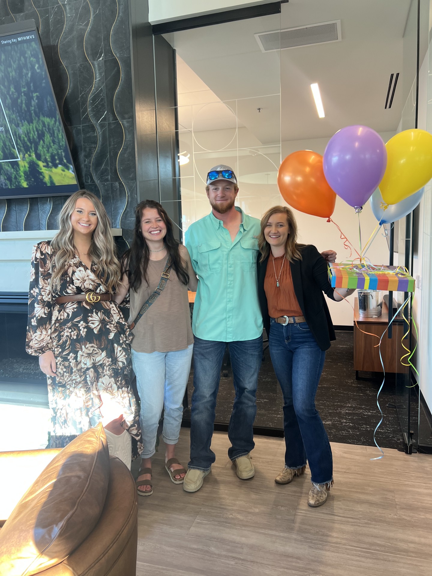 Clients and their homebuying team celebrating with balloons
