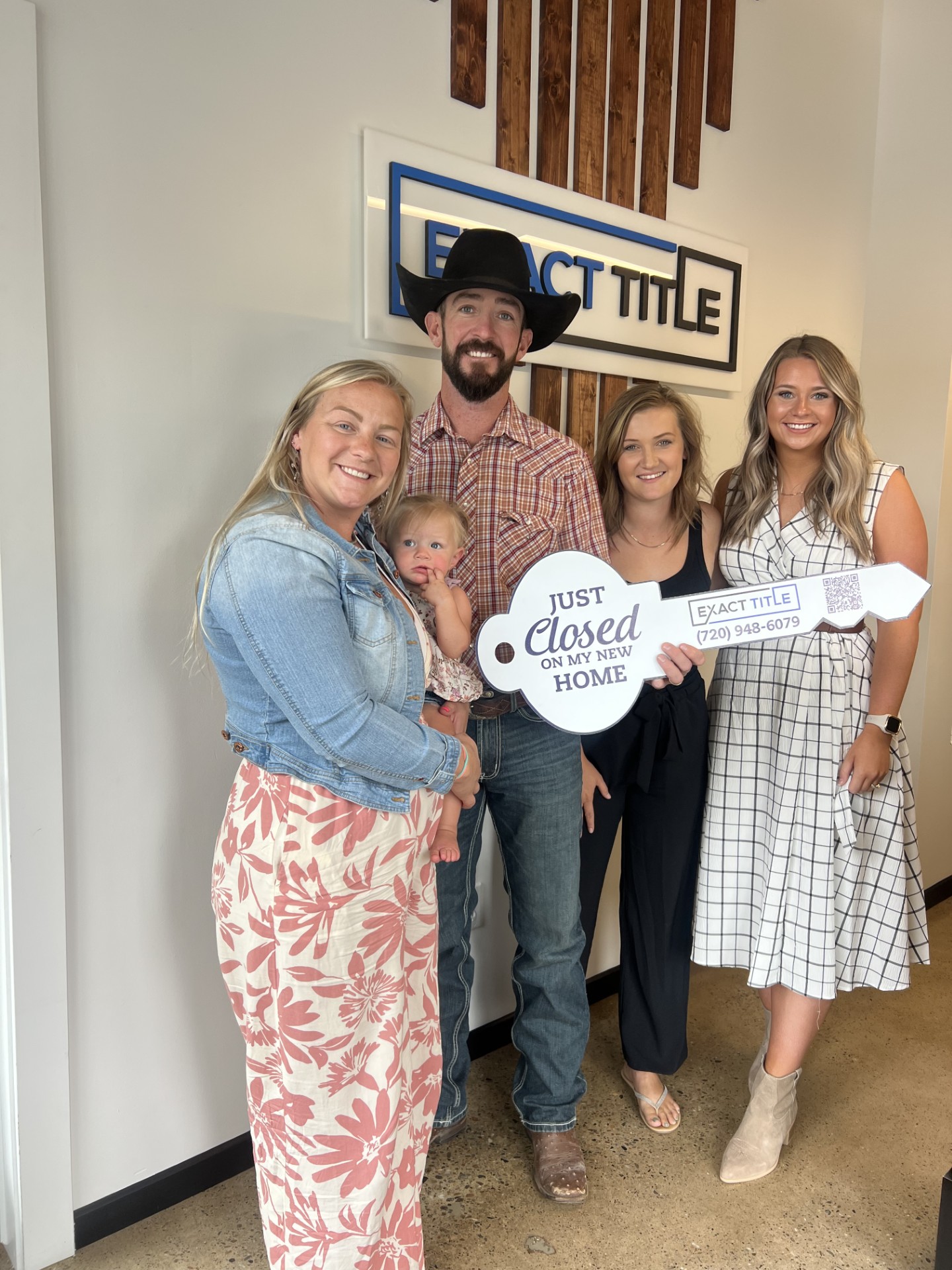 A family celebrating with a Just Closed sign