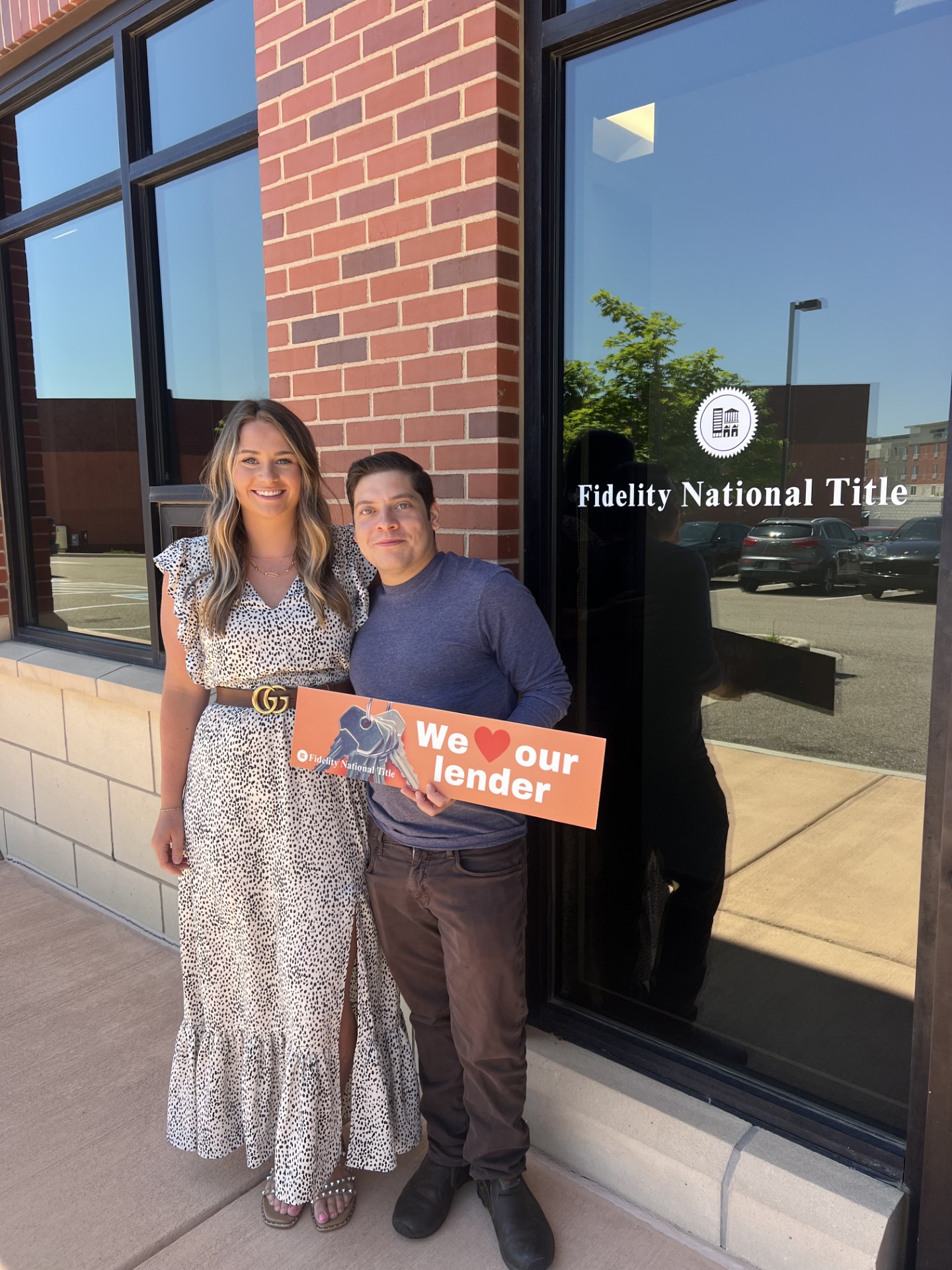 Jordan and a client celebrating outside the title office