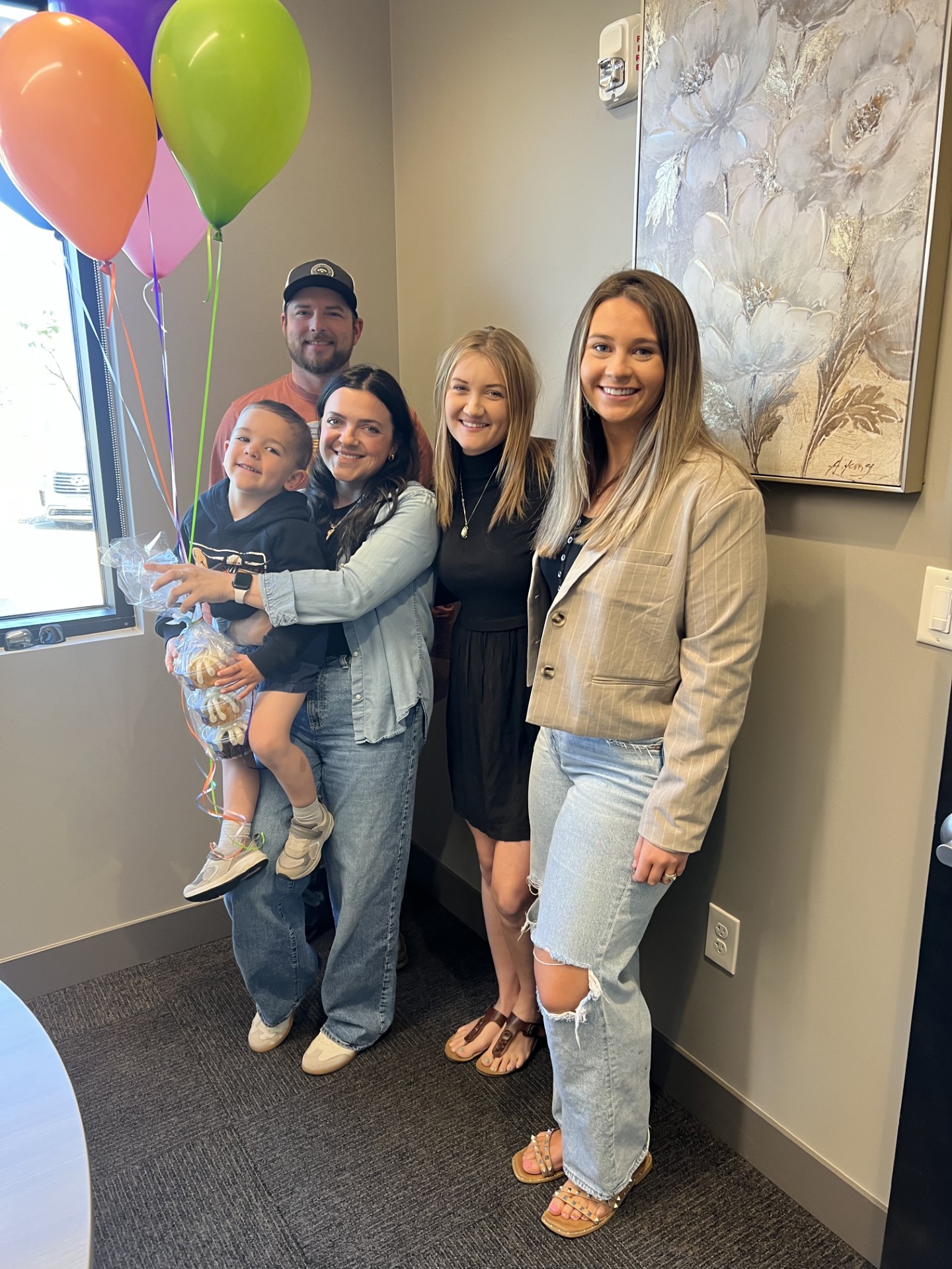 A family and their homebuying team celebrating with balloons