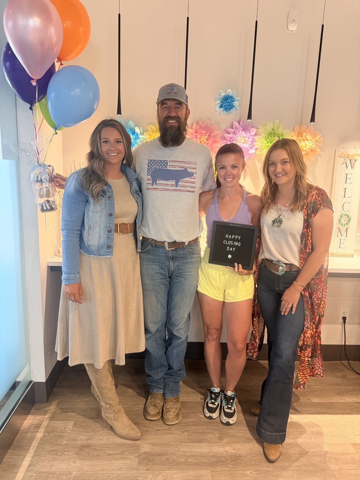 Jordan celebrating closing day with clients and a Realtor partner