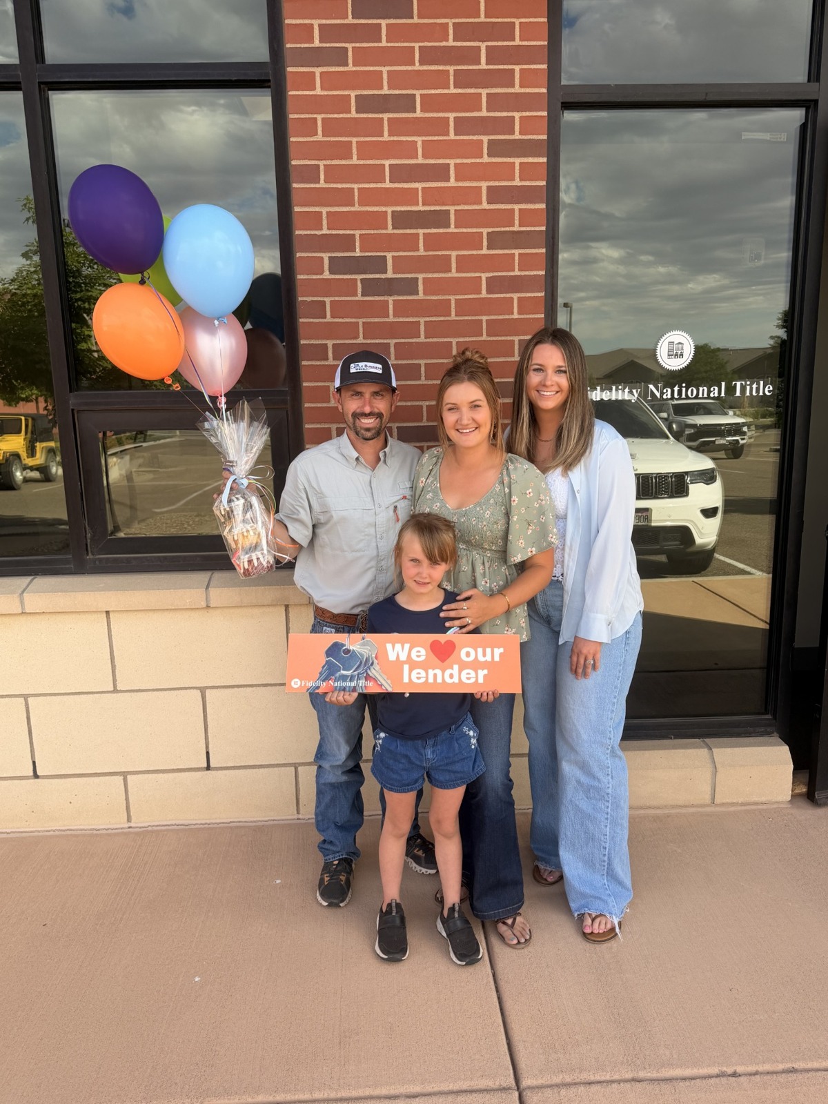 Jordan with a family celebrating their home purchase
