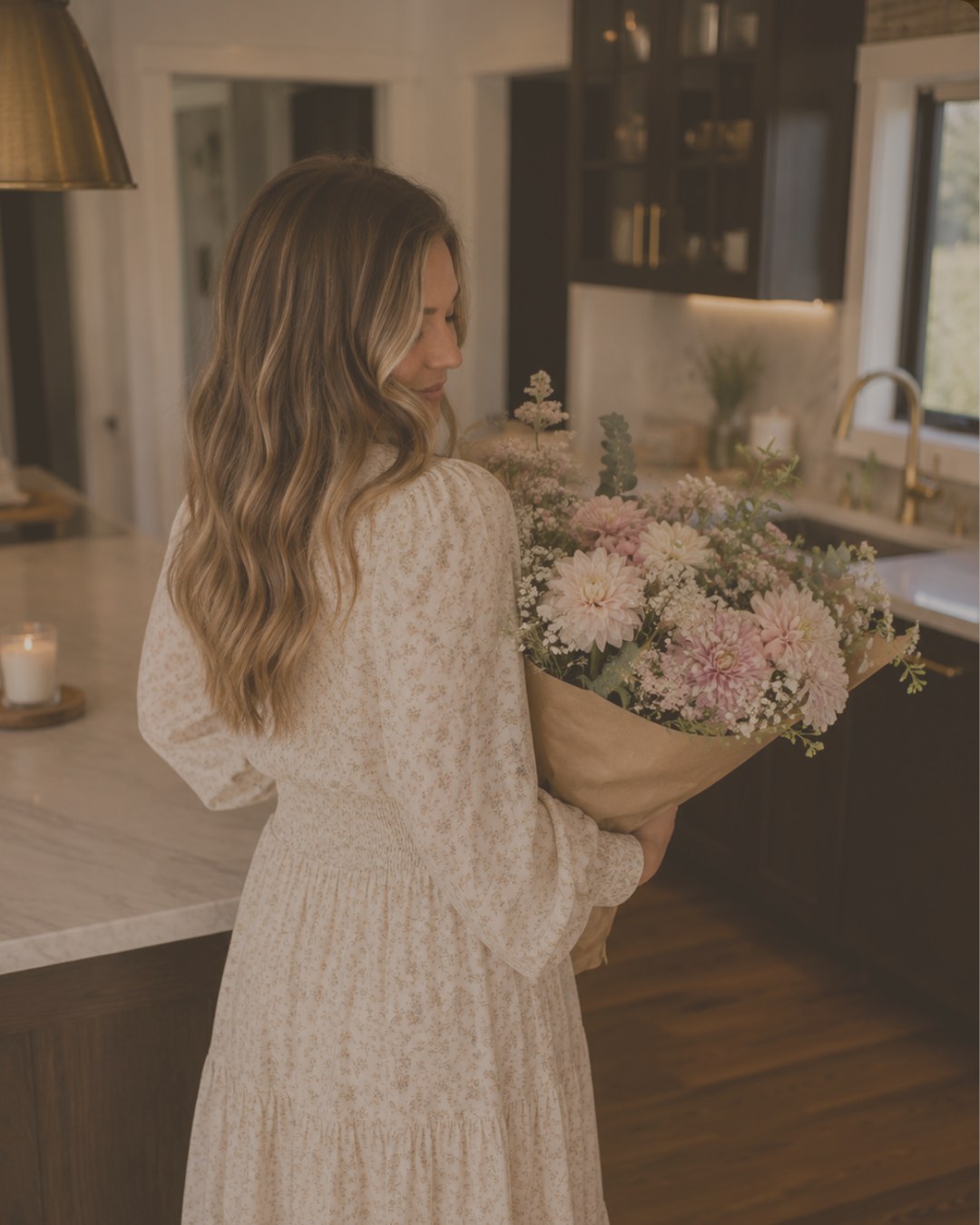 Jordan holding a bouquet in her kitchen